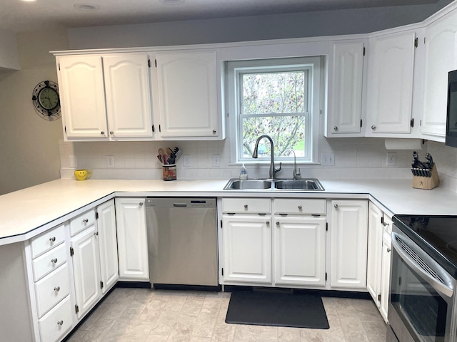 1554 Claudia Ln, Marysville, OH 43040 - kitchen with appliances with stainless steel finishes, a sink, backsplash, white cabinetry, and light countertops