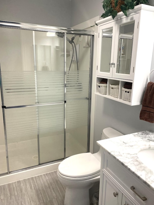 1554 Claudia Ln, Marysville, OH 43040 - full bath with toilet, a shower stall, vanity, and wood finished floors