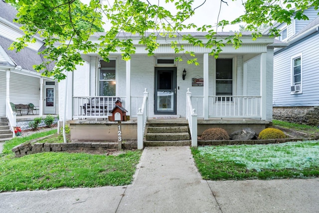 126 W S St, Hillsboro, OH 45133 - view of front of home with a porch, brick siding, and cooling unit
