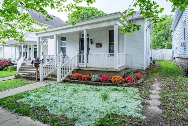 126 W S St, Hillsboro, OH 45133 - view of front of property with covered porch, brick siding, and fence