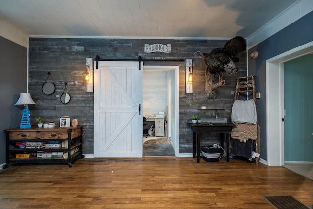 126 W S St, Hillsboro, OH 45133 - living area with wood finished floors, a barn door, baseboards, and wood walls