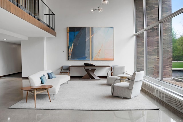 living area with a high ceiling and finished concrete floors