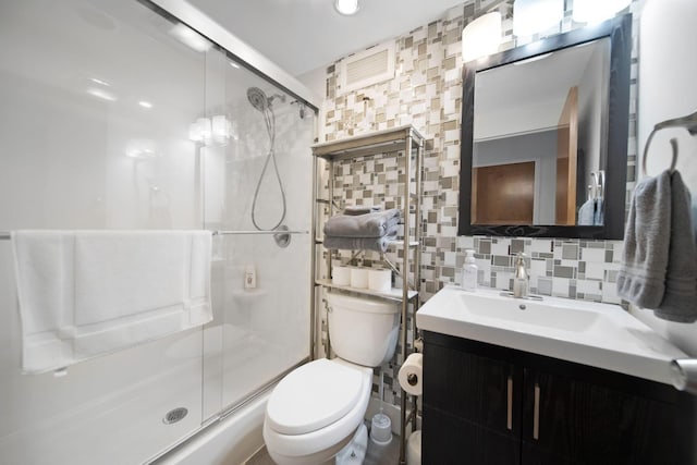 bathroom with a stall shower, tile walls, toilet, and tasteful backsplash