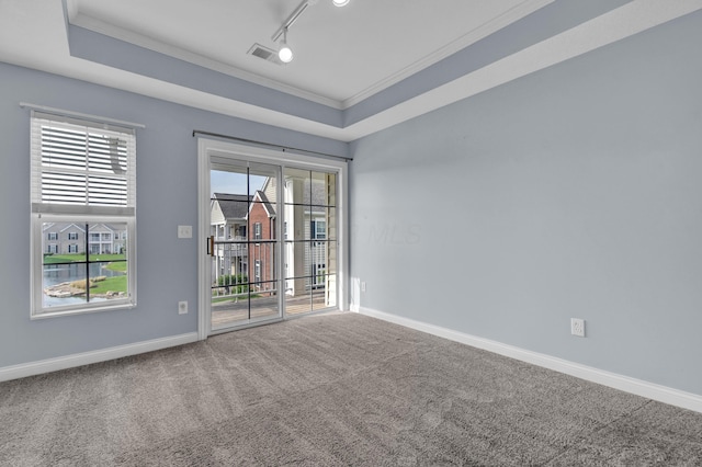 spare room with visible vents, ornamental molding, carpet, and baseboards