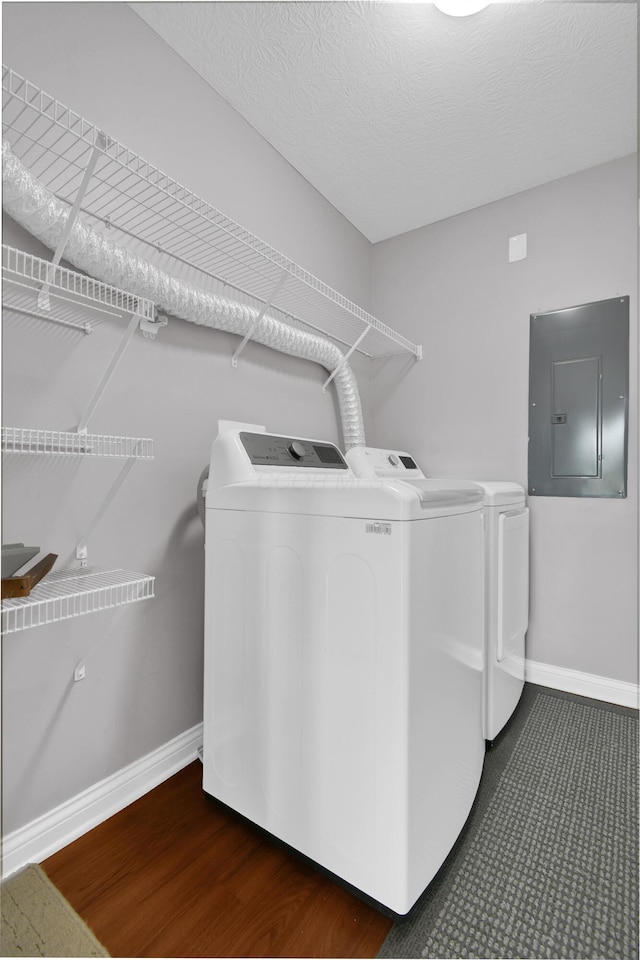 laundry area with separate washer and dryer, laundry area, baseboards, and electric panel