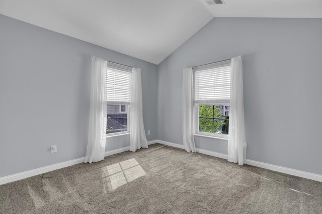 unfurnished room featuring baseboards, visible vents, carpet flooring, and lofted ceiling