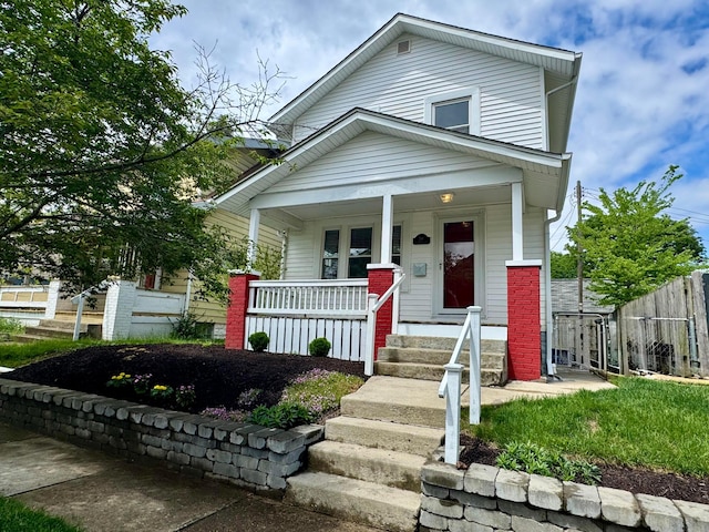 view of front facade featuring a porch and fence