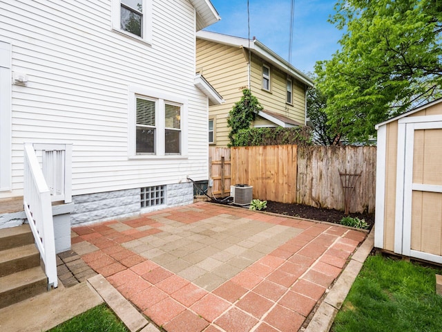 294 E Morrill Ave, Columbus, OH 43207 - view of patio with fence, a storage shed, an outdoor structure, and central AC unit
