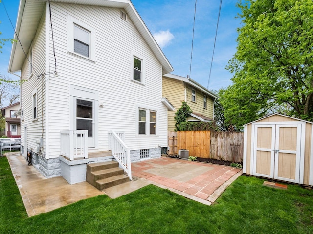 294 E Morrill Ave, Columbus, OH 43207 - rear view of property featuring a patio, a storage shed, central AC, and an outbuilding