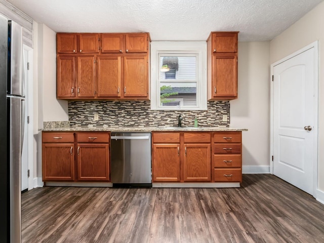 294 E Morrill Ave, Columbus, OH 43207 - kitchen featuring appliances with stainless steel finishes, dark wood-type flooring, a sink, and a textured ceiling