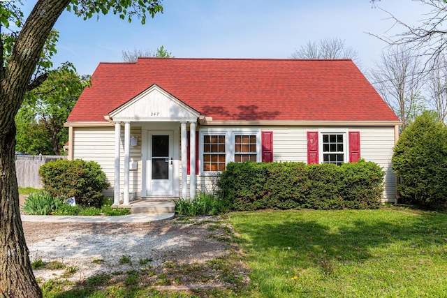247 Bank St, Mount Gilead, OH 43338 - new england style home with fence, a shingled roof, and a front yard