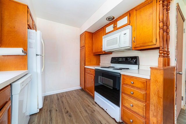 247 Bank St, Mount Gilead, OH 43338 - kitchen featuring brown cabinets, light wood-type flooring, light countertops, baseboards, and white appliances
