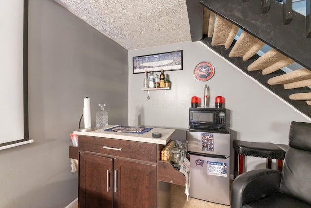 9137 Parkpoint Ln, Lewis Center, OH 43035 - bar with black microwave, stairway, and a textured ceiling