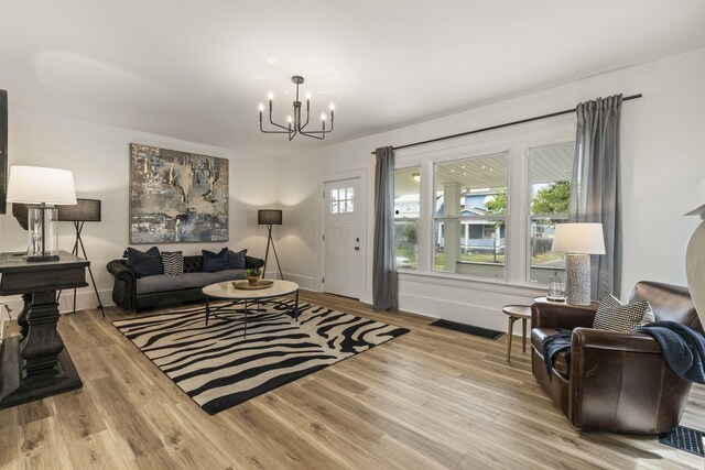 147 N Ogden Ave, Columbus, OH 43204 - living room with baseboards, a chandelier, and wood finished floors