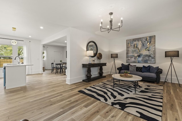 147 N Ogden Ave, Columbus, OH 43204 - living area featuring recessed lighting, baseboards, a chandelier, and light wood finished floors
