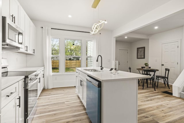 147 N Ogden Ave, Columbus, OH 43204 - kitchen featuring recessed lighting, a sink, light wood-style flooring, and stainless steel appliances