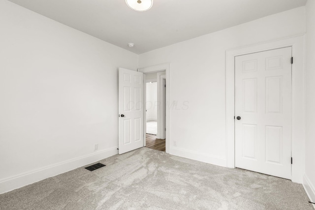 147 N Ogden Ave, Columbus, OH 43204 - unfurnished bedroom with baseboards, carpet, and visible vents