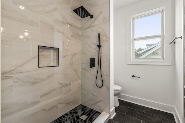 147 N Ogden Ave, Columbus, OH 43204 - bathroom featuring baseboards, tile patterned flooring, toilet, and tiled shower