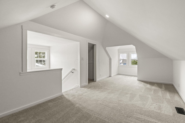 147 N Ogden Ave, Columbus, OH 43204 - additional living space with visible vents, baseboards, carpet, and lofted ceiling