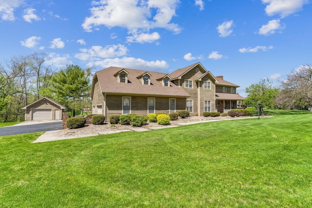 125 W Woodmere Dr, Tiffin, OH 44883 - view of front of house featuring an outdoor structure, a front lawn, a chimney, and a detached garage
