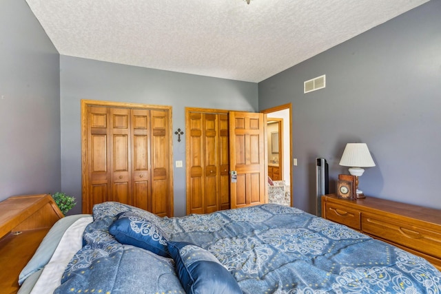 125 W Woodmere Dr, Tiffin, OH 44883 - bedroom featuring visible vents, a textured ceiling, and multiple closets
