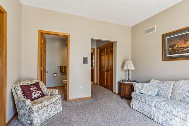 125 W Woodmere Dr, Tiffin, OH 44883 - carpeted living area with a textured ceiling, baseboards, and visible vents