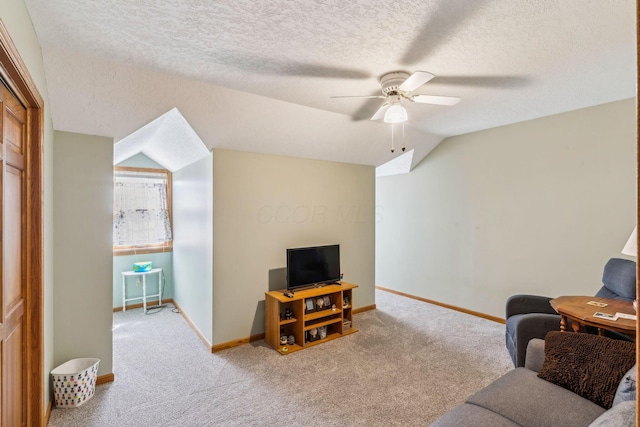 125 W Woodmere Dr, Tiffin, OH 44883 - carpeted living room featuring baseboards, a textured ceiling, ceiling fan, and vaulted ceiling