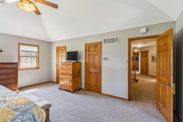 125 W Woodmere Dr, Tiffin, OH 44883 - bedroom with light colored carpet, a ceiling fan, baseboards, vaulted ceiling, and visible vents