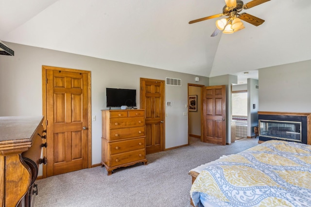 125 W Woodmere Dr, Tiffin, OH 44883 - bedroom with visible vents, carpet floors, baseboards, high vaulted ceiling, and a glass covered fireplace