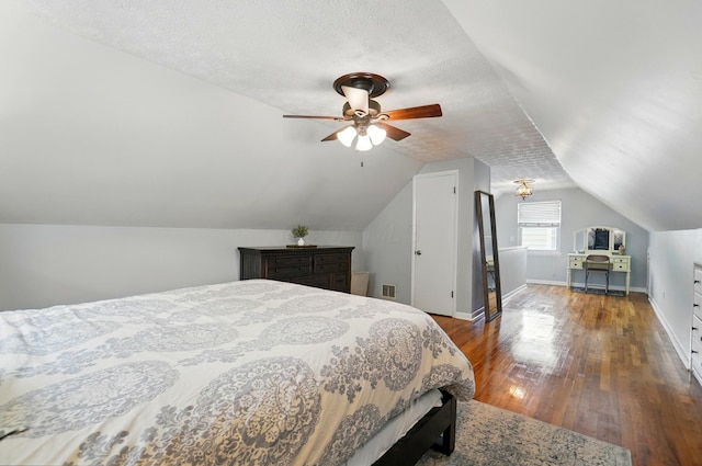 bedroom with hardwood / wood-style floors, visible vents, baseboards, ceiling fan, and lofted ceiling