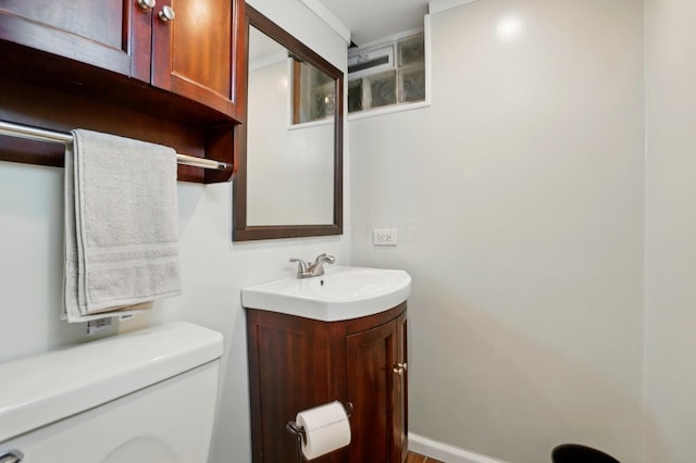 half bathroom with toilet and vanity