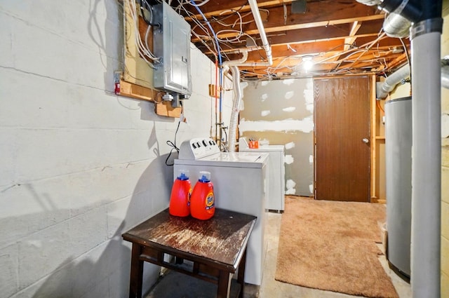 unfinished below grade area with washing machine and clothes dryer, carpet floors, water heater, and electric panel
