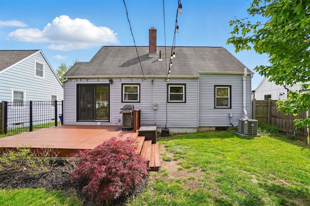 back of house with a yard, a fenced backyard, a wooden deck, cooling unit, and a chimney