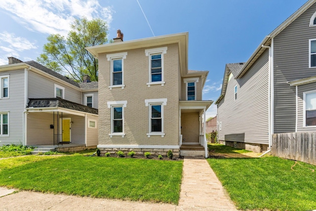 61 Dakota Ave, Columbus, OH 43222 - view of front facade featuring fence, a front lawn, brick siding, a chimney, and covered porch