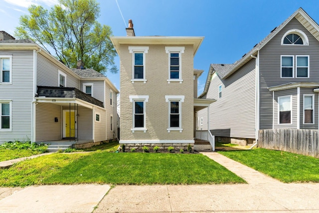 61 Dakota Ave, Columbus, OH 43222 - view of front of property with brick siding, fence, a chimney, and a front yard