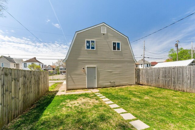 61 Dakota Ave, Columbus, OH 43222 - rear view of house featuring a yard, a fenced backyard, and a gambrel roof
