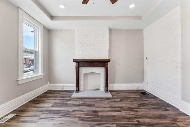 61 Dakota Ave, Columbus, OH 43222 - unfurnished living room with a tray ceiling, wood finished floors, and a wealth of natural light