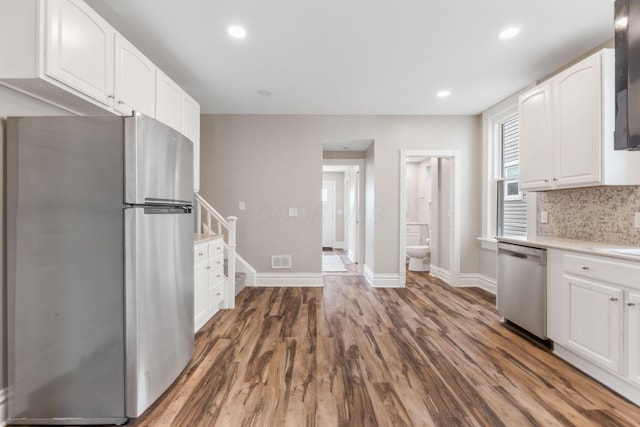 61 Dakota Ave, Columbus, OH 43222 - kitchen featuring visible vents, light countertops, white cabinets, stainless steel appliances, and dark wood-type flooring