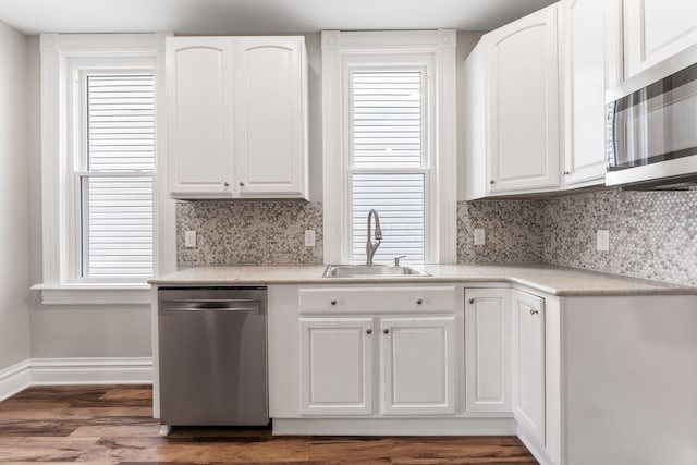 61 Dakota Ave, Columbus, OH 43222 - kitchen with white cabinets, stainless steel appliances, a sink, and wood finished floors