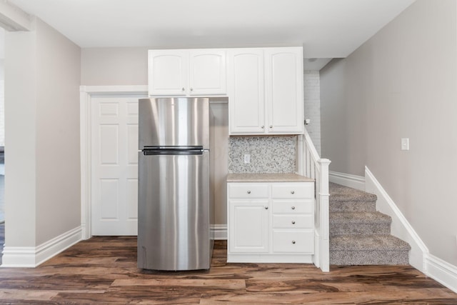 61 Dakota Ave, Columbus, OH 43222 - kitchen featuring dark wood finished floors, freestanding refrigerator, decorative backsplash, and white cabinets