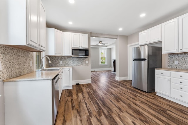 61 Dakota Ave, Columbus, OH 43222 - kitchen featuring a sink, white cabinets, appliances with stainless steel finishes, and dark wood-style floors