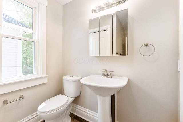 61 Dakota Ave, Columbus, OH 43222 - half bathroom with toilet, baseboards, and a sink