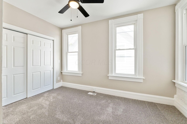 61 Dakota Ave, Columbus, OH 43222 - unfurnished bedroom with visible vents, a closet, baseboards, a ceiling fan, and carpet