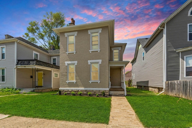 61 Dakota Ave, Columbus, OH 43222 - view of front of property featuring brick siding, a front yard, a chimney, and covered porch