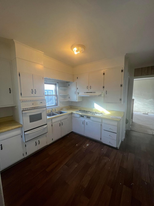 126 S Seffner Ave, Marion, OH 43302 - kitchen with a warming drawer, oven, under cabinet range hood, dark wood-type flooring, and white cabinets