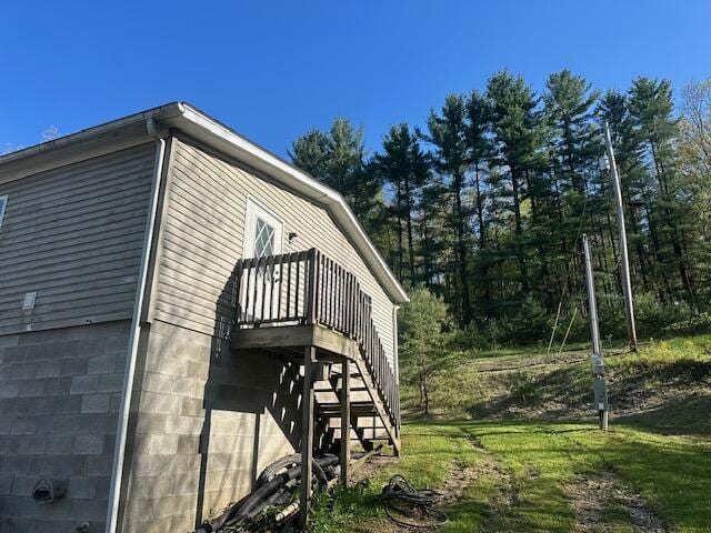 view of property exterior featuring stairs and a deck