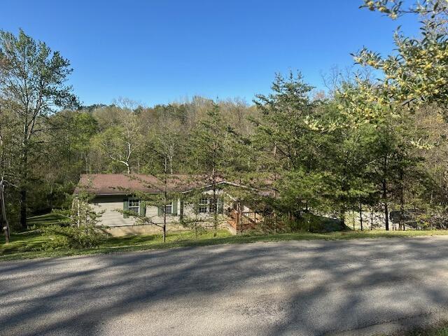 view of front of house featuring a forest view