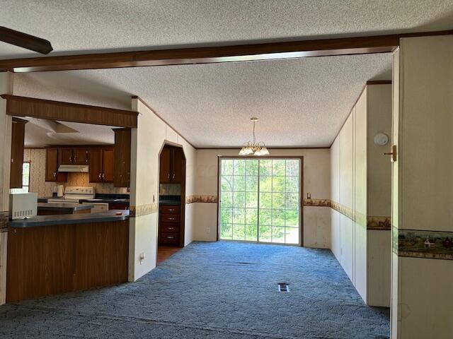 35310 Geiger Rd, Logan, OH 43138 - kitchen with a textured ceiling, carpet, under cabinet range hood, dark countertops, and electric range
