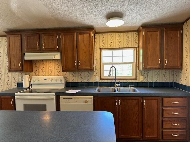35310 Geiger Rd, Logan, OH 43138 - kitchen featuring wallpapered walls, a sink, white appliances, under cabinet range hood, and a textured ceiling