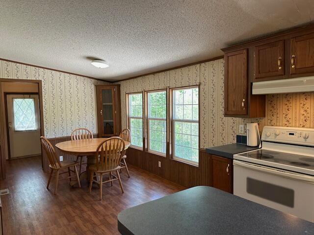 35310 Geiger Rd, Logan, OH 43138 - dining room with wallpapered walls, a textured ceiling, and wood finished floors